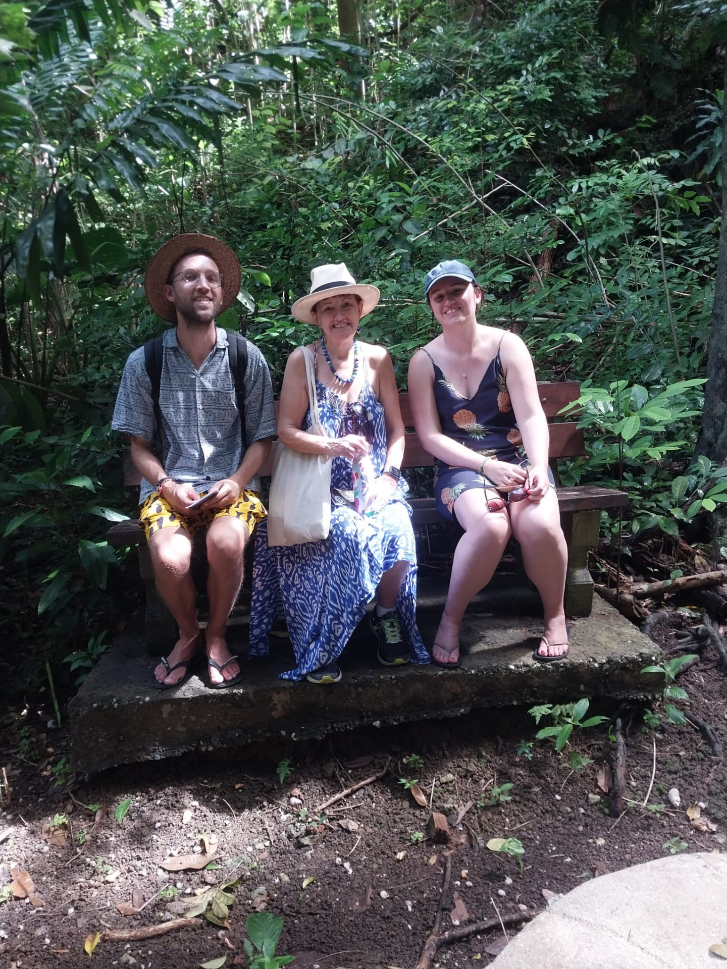Guests resting on a shaded bench in a tropical Barbados gully during a private island tour