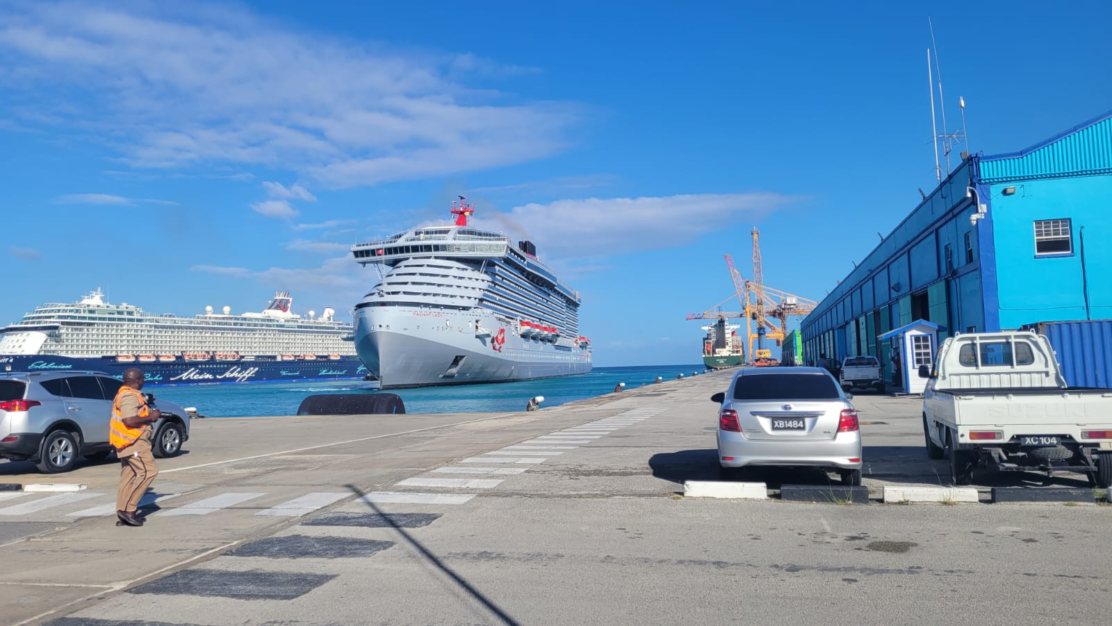 Cruise ship docked at the Bridgetown cruise terminal in Barbados with transfer vehicles waiting on the pier
