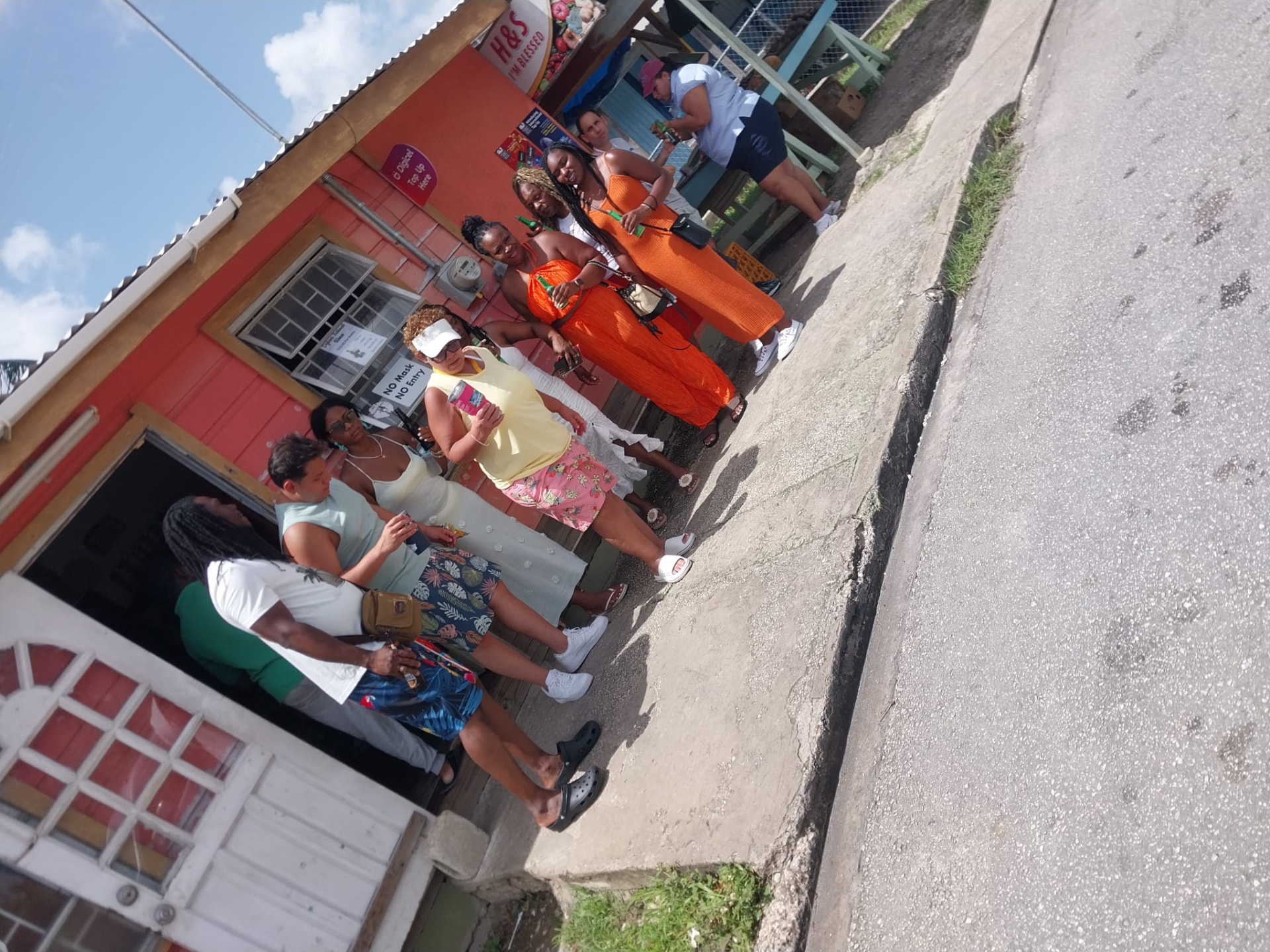Guests stopping at a colourful local Bajan shop for cold drinks during a sightseeing island tour