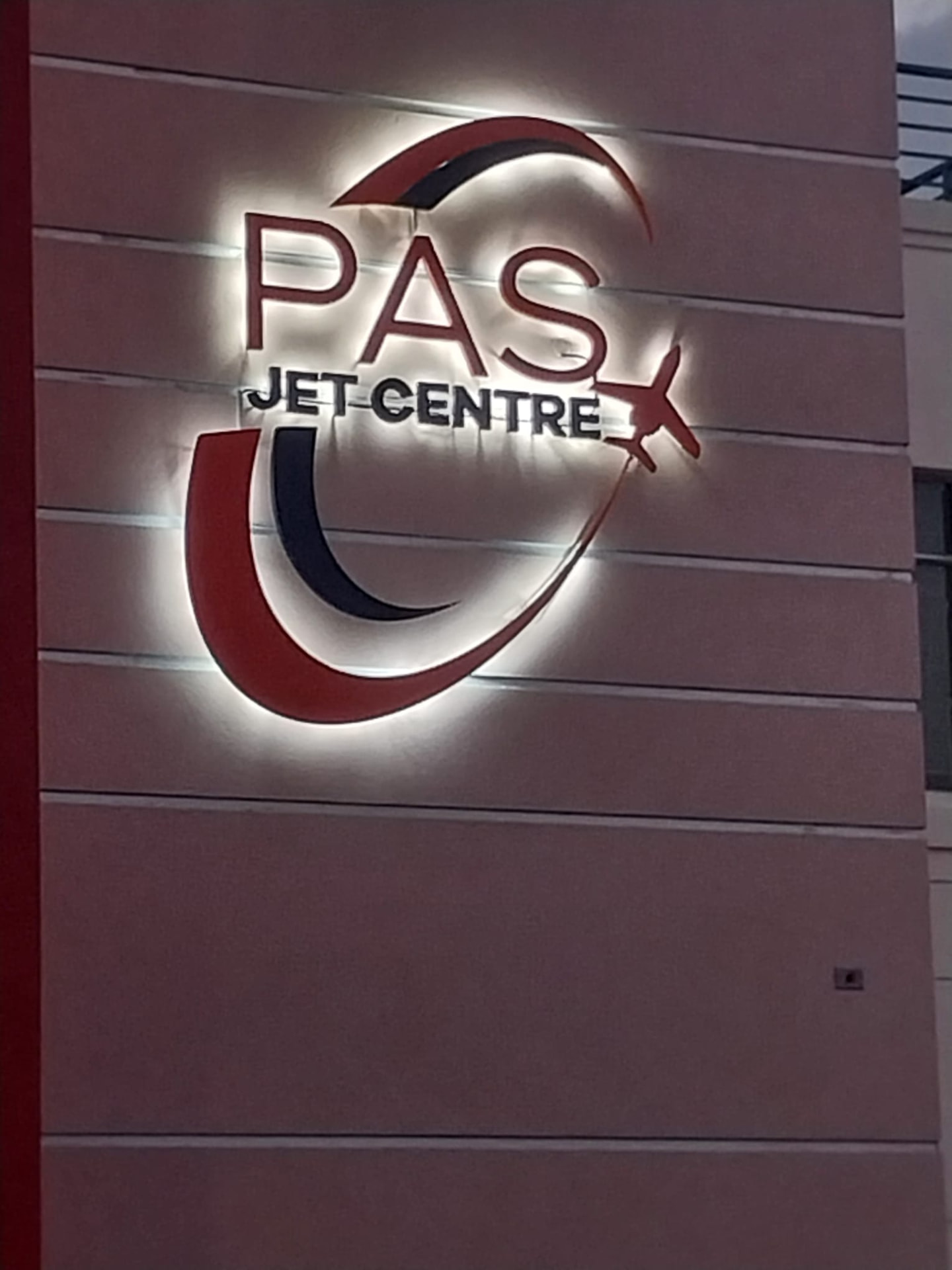 Illuminated PAS Jet Centre sign at the private aviation terminal beside Grantley Adams International Airport, Barbados