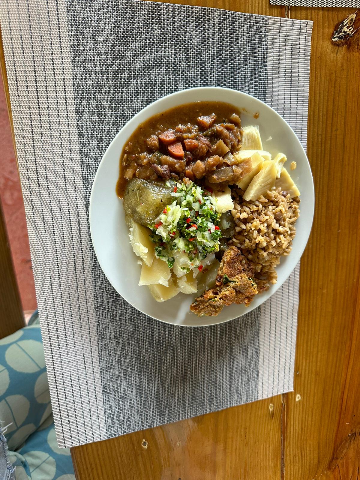 Plate of local Bajan food with fish cakes, rice and peas and ground provisions enjoyed on a Barbados island tour