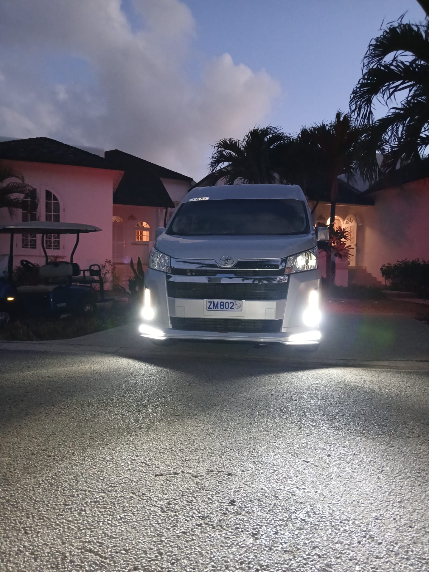 On The House Taxi Service luxury van arriving at Royal Westmoreland villas in Barbados at dusk after an airport transfer