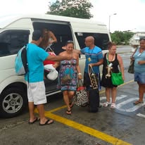 Group transportation in Barbados — guests boarding an On The House Taxi Service passenger van