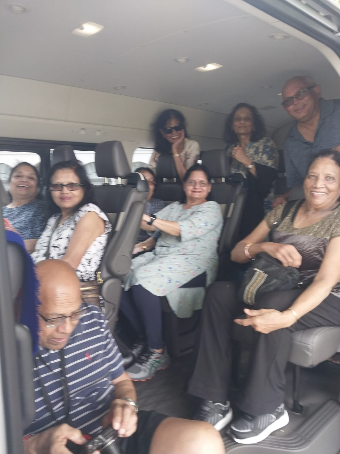 Guests seated inside the air-conditioned On The House Taxi Service luxury van during a Barbados group transfer