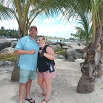 Happy couple on a Barbados beach during an island tour with On The House Taxi Service