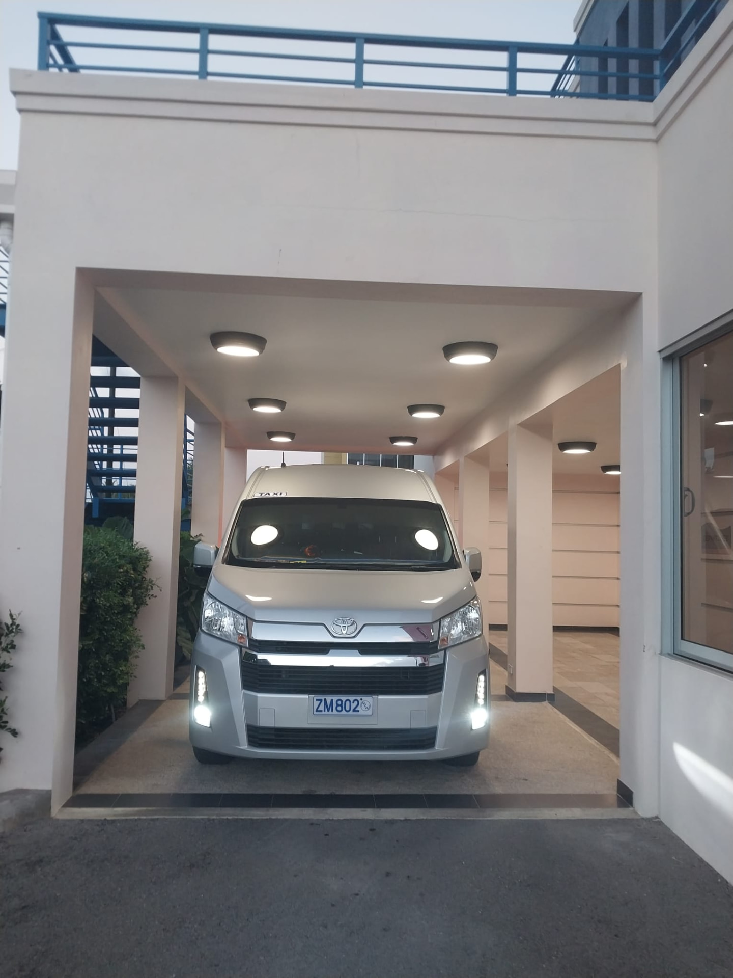 On The House Taxi Service luxury van waiting at the PAS Jet Centre private jet terminal in Barbados for a passenger transfer