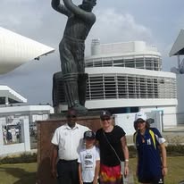 Family photo at the legendary Kensington Oval cricket stadium during a Barbados sightseeing tour
