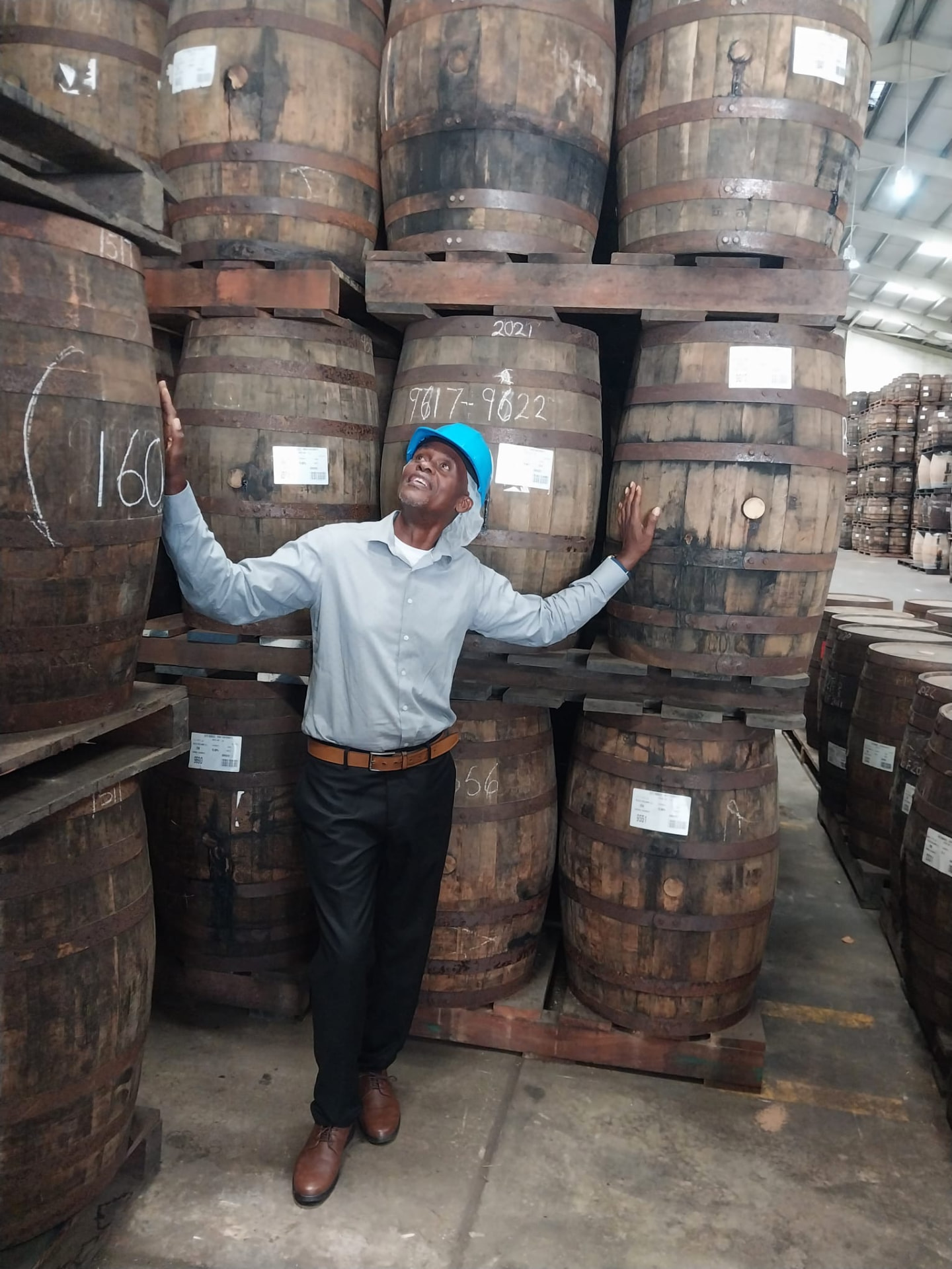 Anthony Clarke of On The House Taxi Service among rum barrels on a Mount Gay rum tour in Barbados