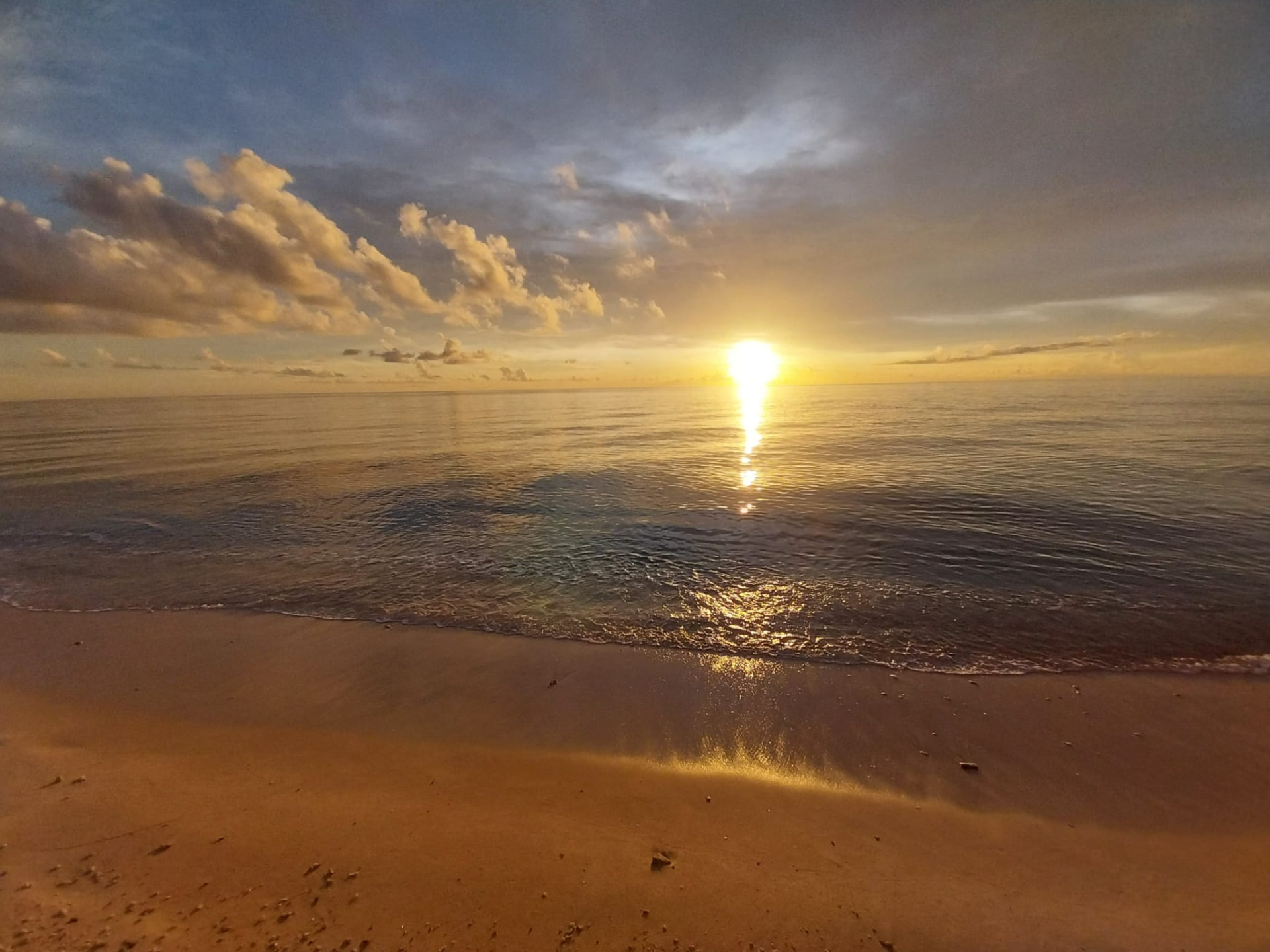Wide sunset view over a calm west coast Barbados beach on an On The House Taxi Service sunset run