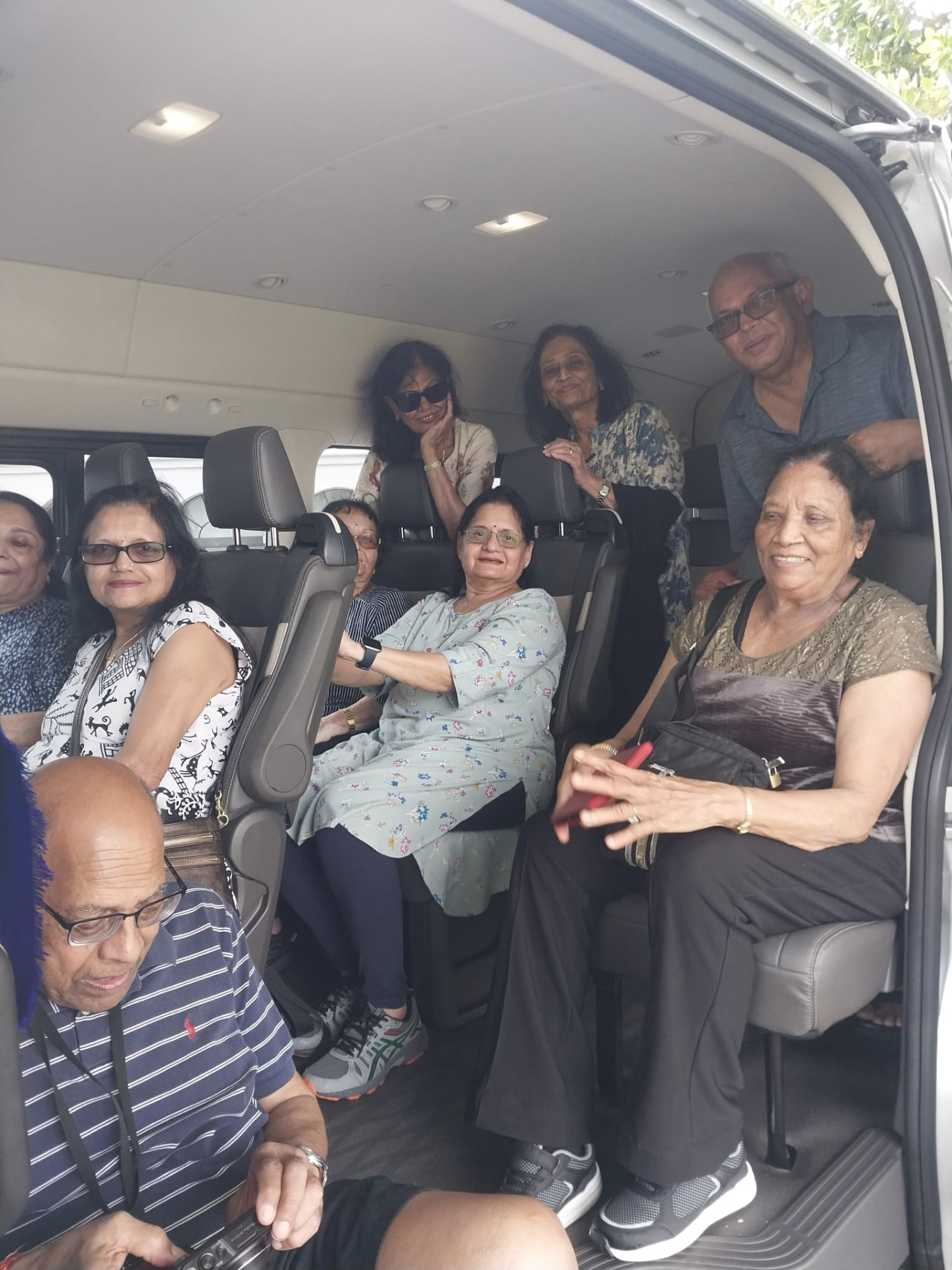 Guests seated comfortably inside the air-conditioned 13-passenger On The House Taxi Service van in Barbados